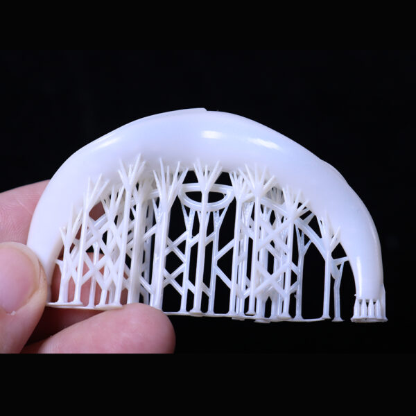 Part of a bracelet model with still - attached support structures, made from 800D white wax castable resin