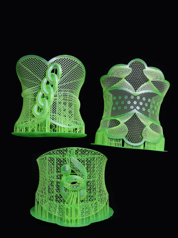 Three bracelet models printed by 3D printer with green wax castable resin, featuring detailed lattice and adornment designs