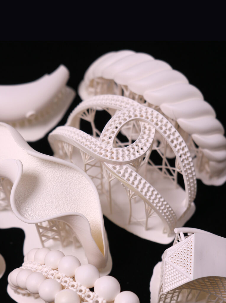 A set of intricately - designed resin bracelets, 3D printed with white wax resin. These bracelets showcase diverse styles, from those with flowing, wavy contours to ones featuring elaborate open - work and spherical elements.