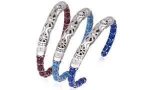 Three silver - toned bangles with intricate hollow - out patterns and colorful decorative parts