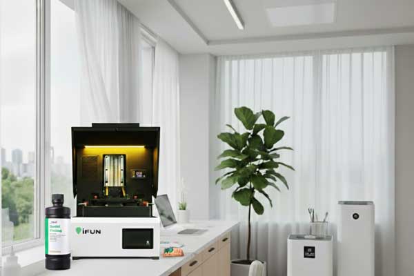 A bottle of low-odor dental casting resin next to a 3D printer in a clean, professional dental lab setting, highlighting a comfortable and pleasant working environment.