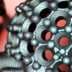 Macro shot of a 3D printed jewelry piece showing prominent layer lines and the staircase effect on a black castable resin model, illustrating the need for surface smoothing.