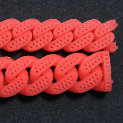 Two red 3D printed wax Cuban link chain models featuring intricate interlocking links and pre-drilled micro pave diamond setting holes for lost-wax jewelry casting.