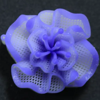 Top view of a purple 3D printed wax flower pendant model featuring a complex hollow mesh structure and detailed central stamens for lost-wax jewelry casting.