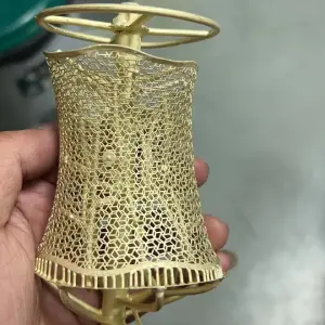 Raw metal cast filigree mesh cuff bracelet with casting sprues attached, produced via 300H castable resin and lost-wax investment casting.