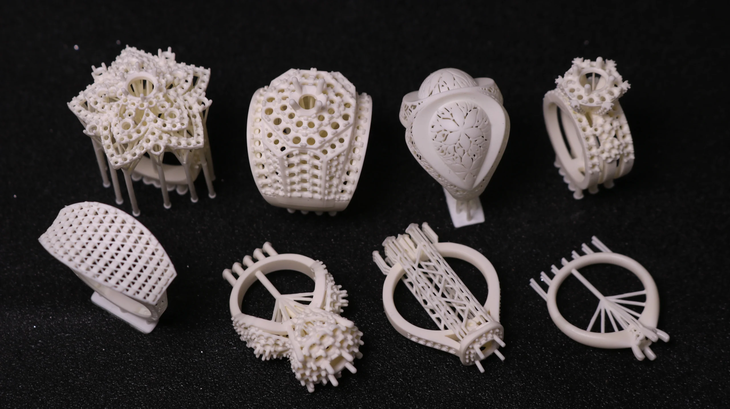 Top view array display of eight different 3D printed castable resin ring patterns in 800D white wax resin