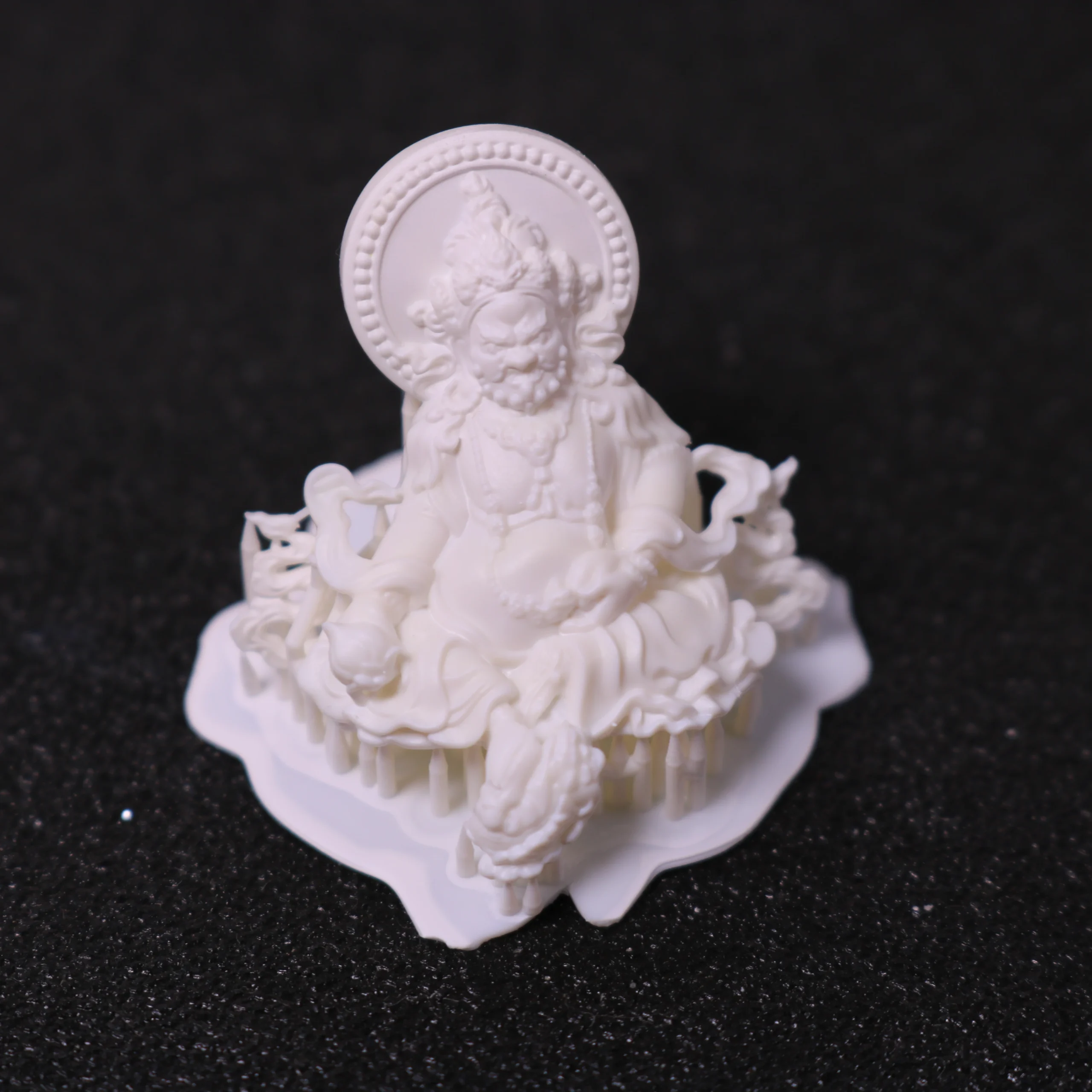 Single 3D printed Buddha figure pendant with supports made of 800D white wax resin