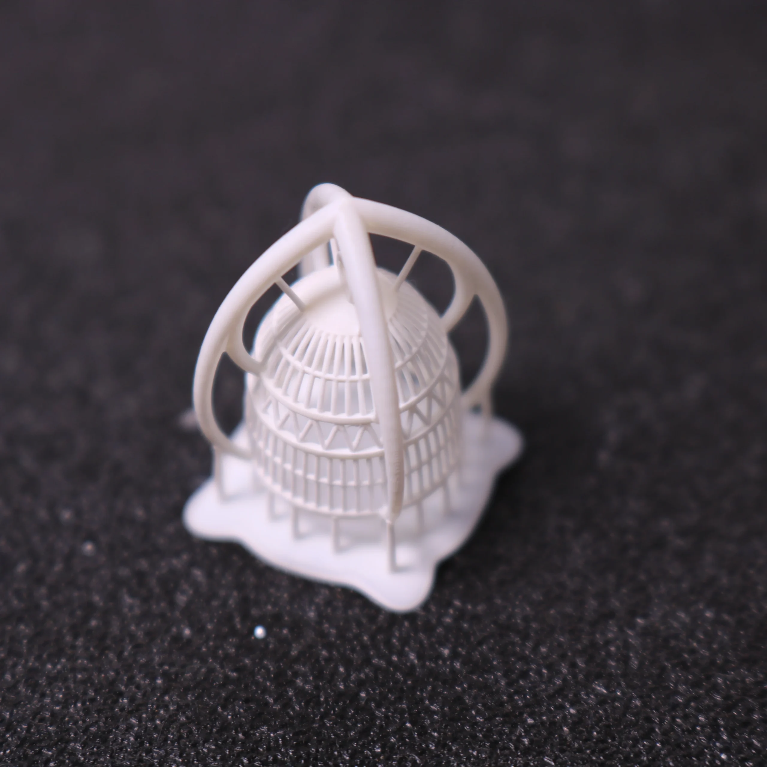 Perspective front view of 3D printed architectural cage dome pendant pattern with supports in 800D white wax resin