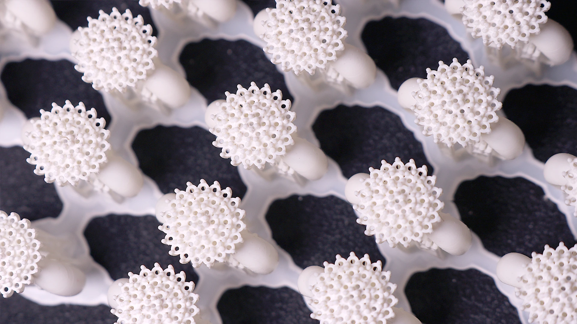 Top view close-up array of 3D printed cluster pave ring mountings in 800D white wax resin