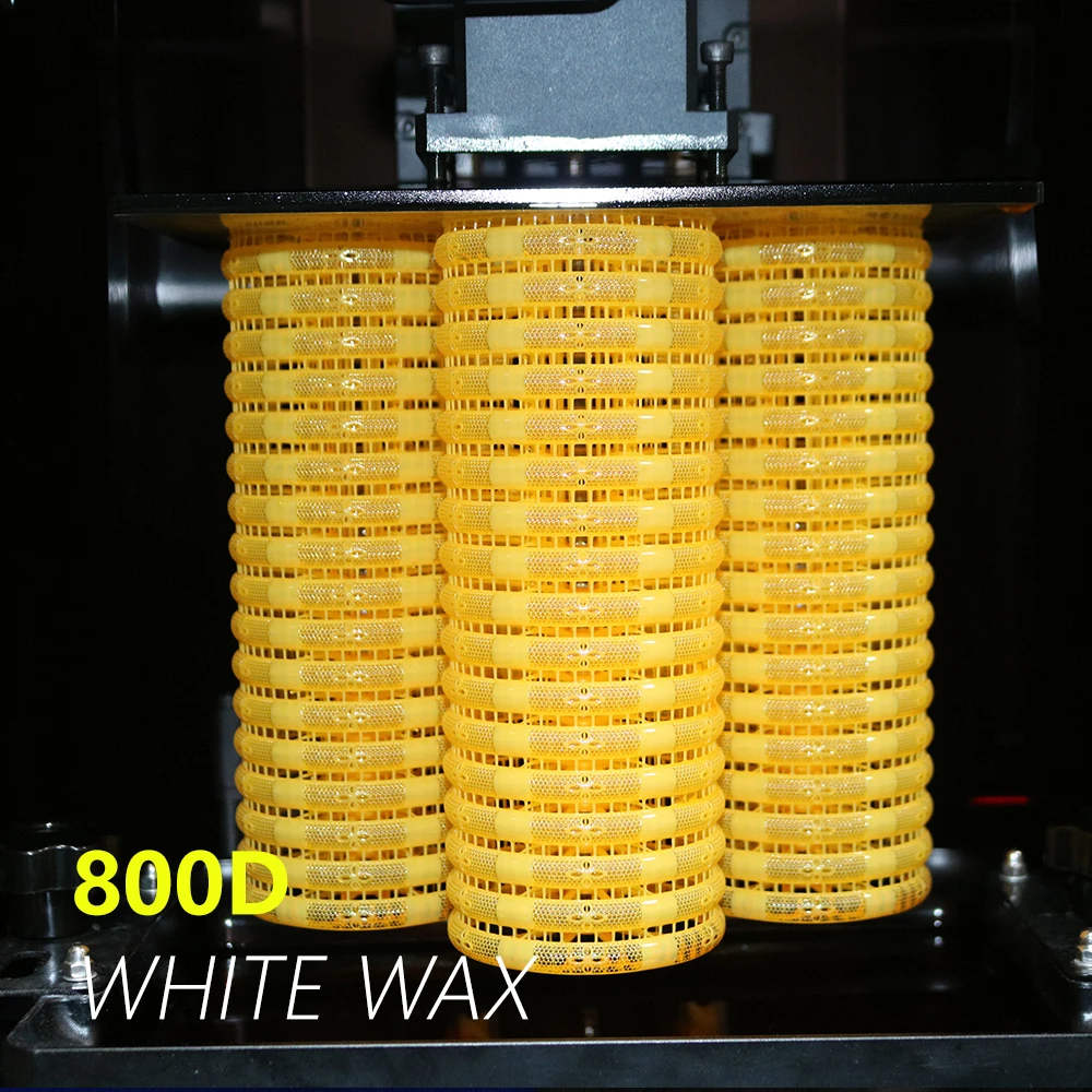 Front view of batch 3D printed filigree bangles hanging on resin printer build plate in 800D white wax resin