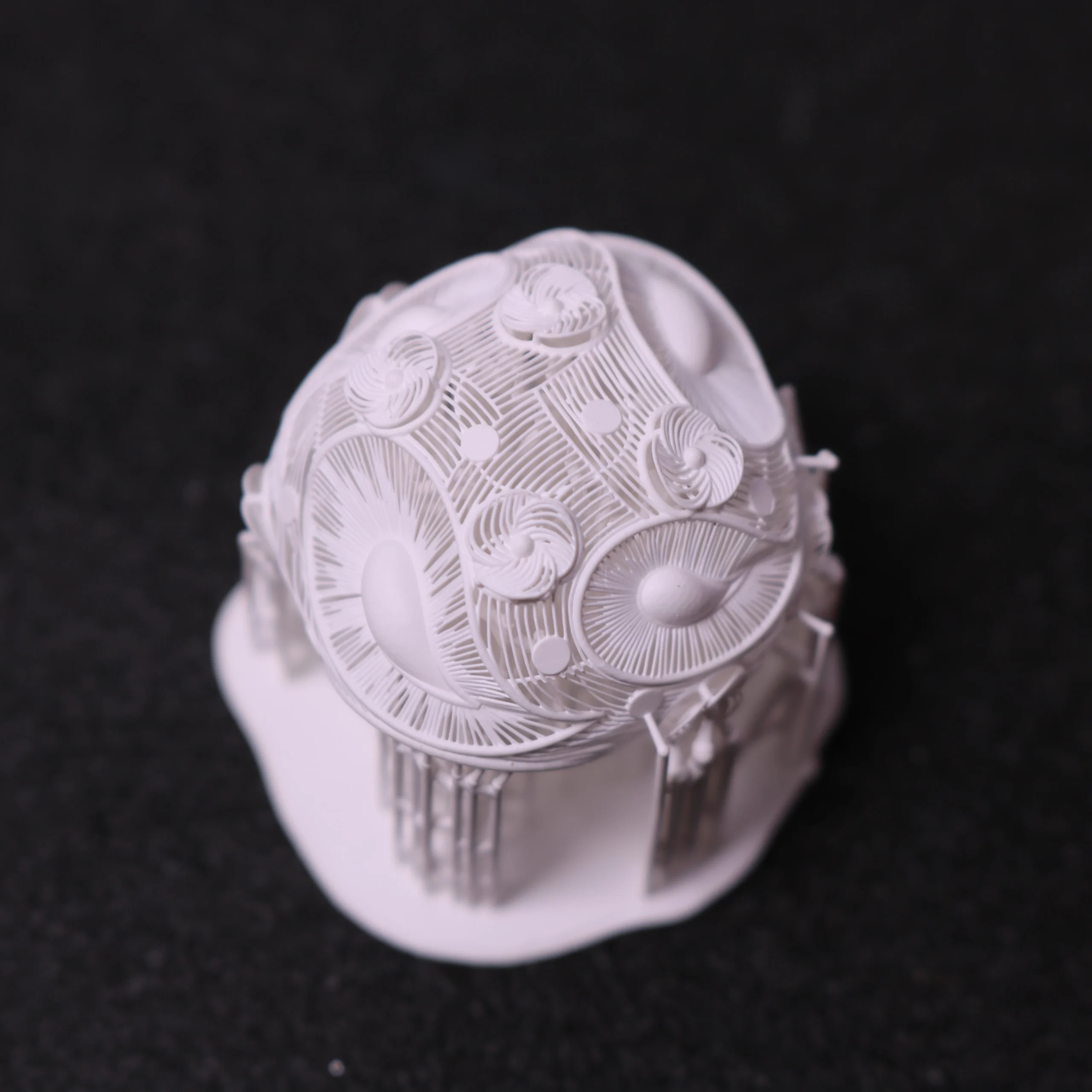 Top close-up view of intricate 3D printed floral filigree dome jewelry pattern in 800D white wax resin