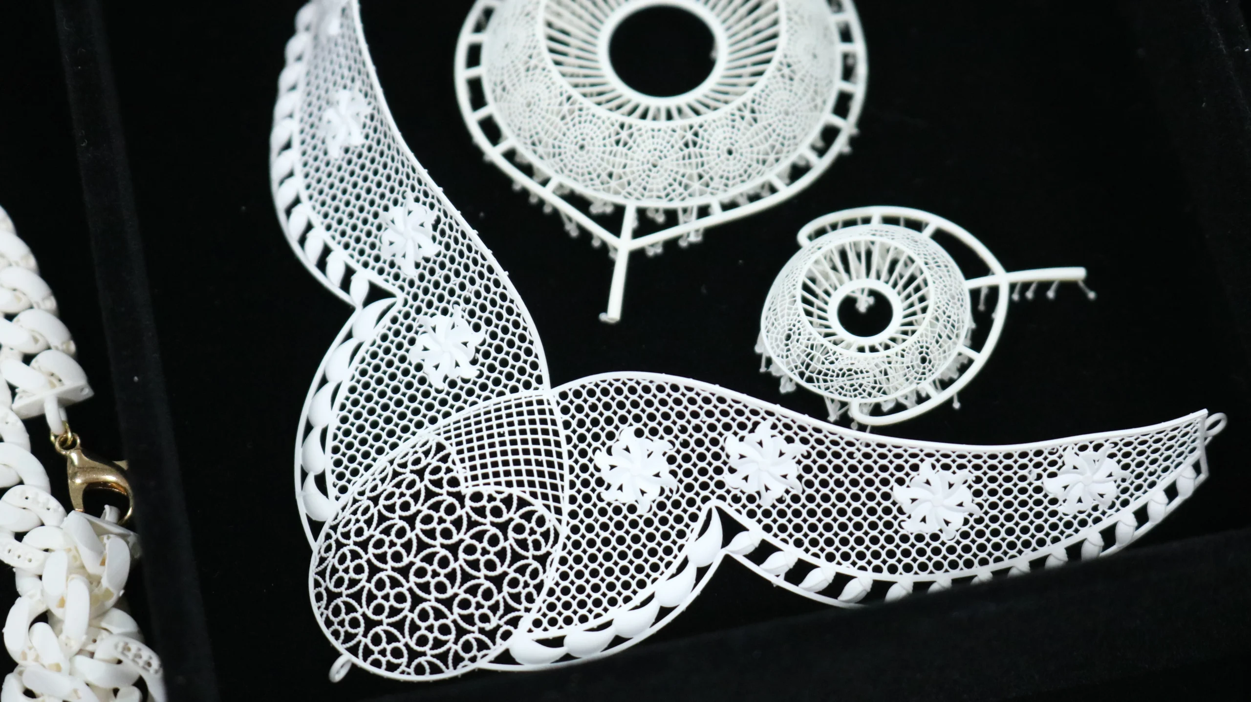 Top view flat lay of 3D printed floral filigree necklace and matching components in 800D white wax resin