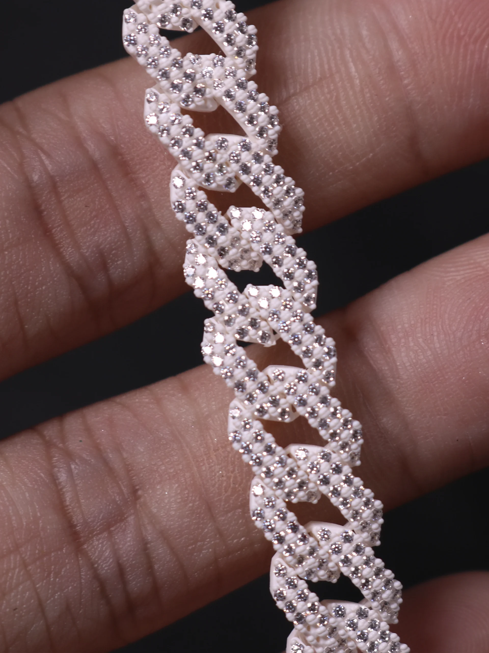 Macro close-up view of 3D printed iced-out Cuban link bracelet with pre-set stones in 800D white wax resin