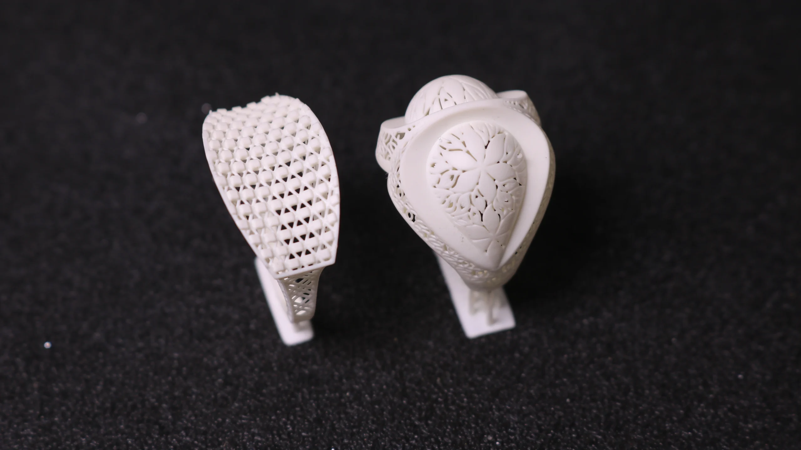 Top view of two 3D printed resin ring patterns featuring mesh lattice band and pear filigree motif in 800D white wax resin