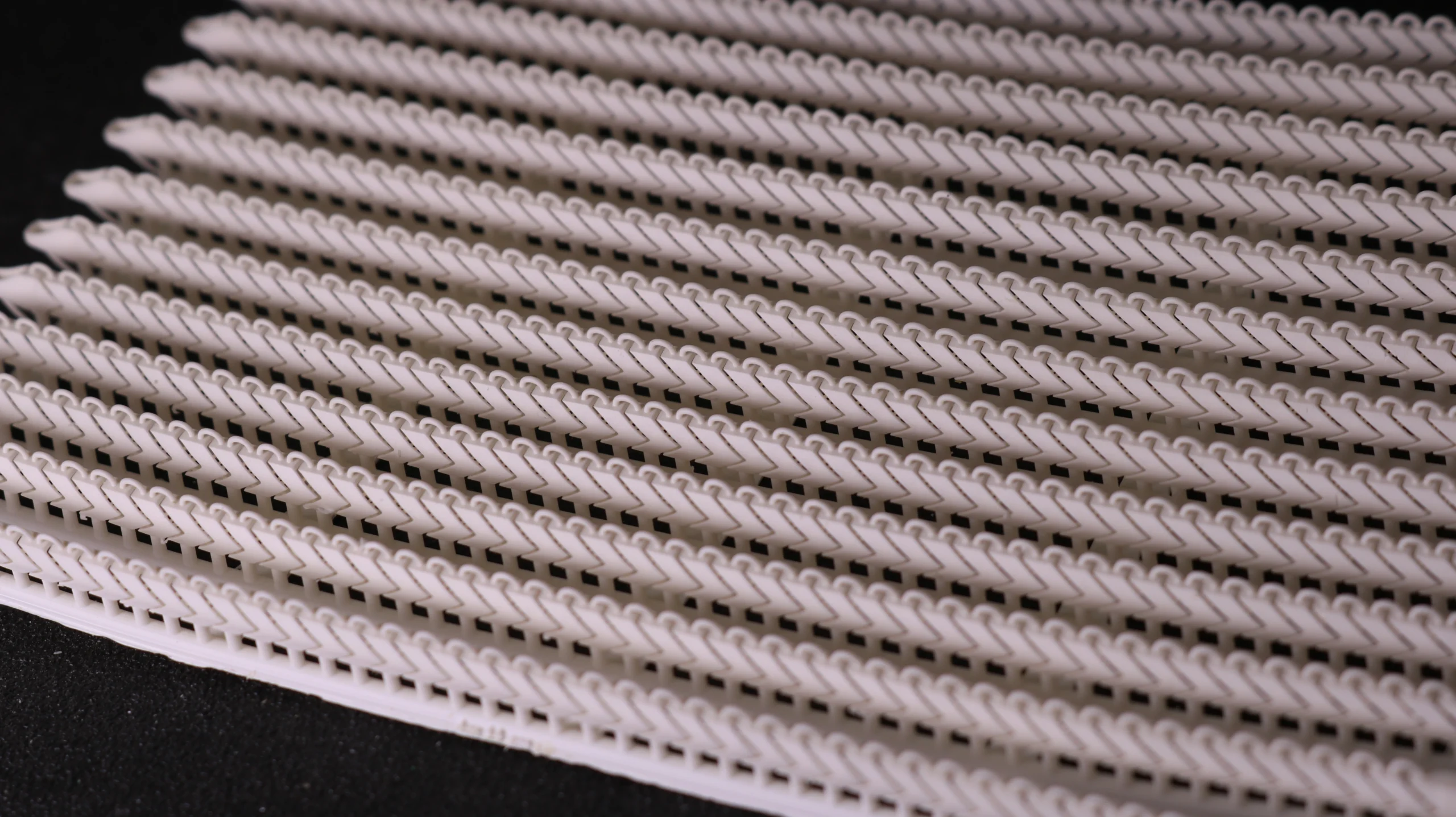 Perspective view of full plate 3D printed V-shape flexible link bracelets with supports in 800D white wax resin