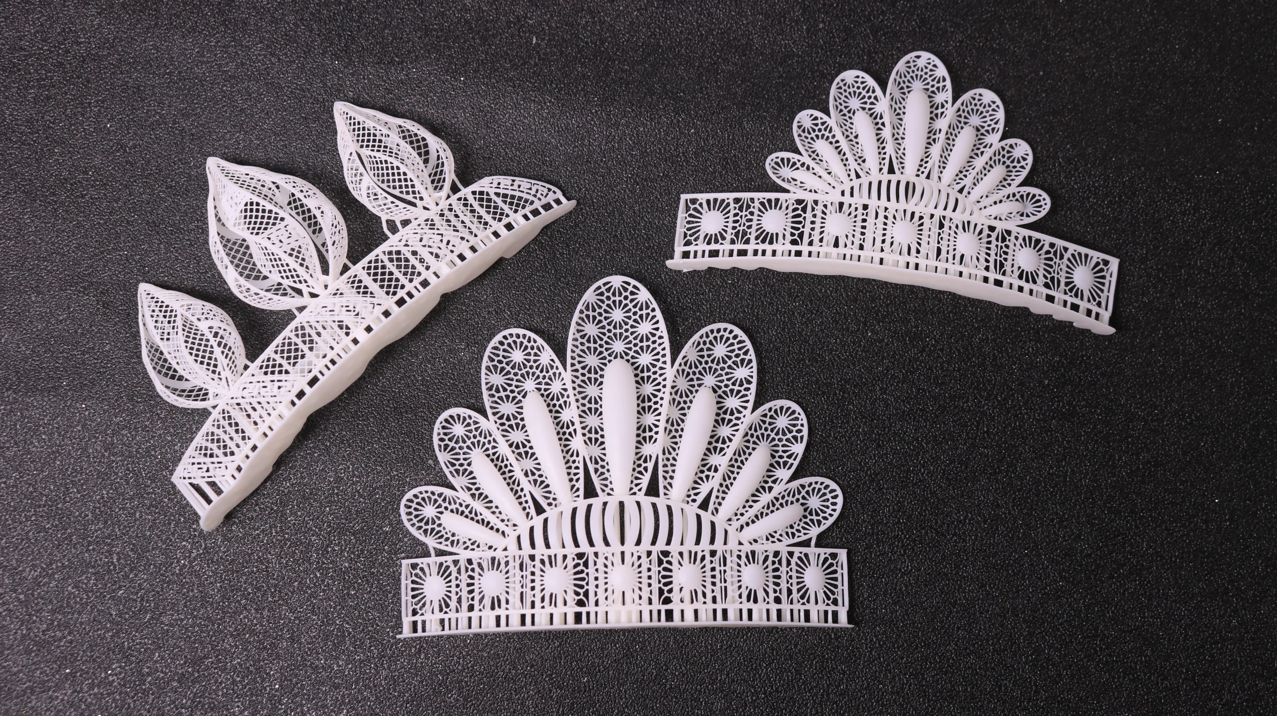 Top view flat lay of three 3D printed vintage royal fan-shaped tiara hairpieces in 800D white wax resin